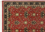 Corner detail of a vintage Indian carpet showing the multi-layered border and cherry red field with floral vinery.