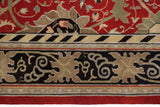 Arts and Crafts inspired border with beige vinery on a navy blue ground against a cherry red field.