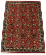 Angled view of the vintage William Morris design carpet showing the full red floral pattern and borders.