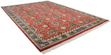 The plush, full pile of a vintage Indian carpet with a red William Morris floral design.
