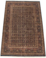 Angled view of a vintage Indian Doroksh carpet with an allover field of dense paisley botehs.