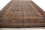 A long view of the vintage Indian Doroksh carpet's dense, allover paisley field and ornate boteh borders.