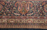 Ornate paisley boteh and intricate border detail of a vintage Indian Doroksh design carpet.