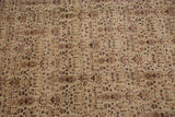 Intricate ivory, beige, and dusty raspberry botanical patterns on a vintage Indian Tabriz carpet.