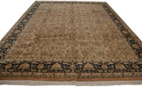 Angled view of a Heriz design rug featuring a pale copper floral field and a dark navy border.