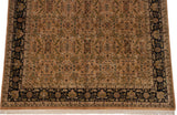 Corner of a Heriz design carpet showing its pale copper field, navy border, and ivory fringe.
