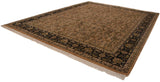 Indian Heriz design carpet shown from an angle, displaying the copper floral field and navy border.