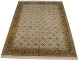 Perspective view of a vintage Agra carpet with a floral lattice and intricate Herati border.