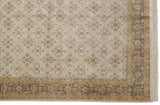 Detailed view of the Herati border and floral bouquets on a hand-knotted Agra carpet corner.