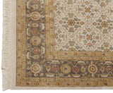 Corner detail of an Agra carpet showing the dusty silver Herati border, floral field, and ivory fringe.