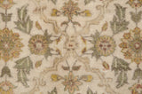Plush hand-knotted pile with floral bouquets in dusty green and gold on an ivory field.