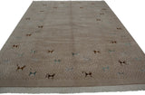 Folk art animals in dark brown, teal, silver on a primitive patterned beige rug field.