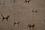 Handwoven Indian folk art carpet with simplistic brown, teal, silver animals and dash motifs.