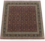 Square Indian Tabriz design carpet with an allover floral field and an intricate navy blue border.