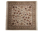 Indian Isfahan design square carpet with scrolling vinery and turtle motifs on an ivory ground.