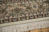 Plush ivory pile and neat fringe bordering the intricate floral pattern of an Isfahan carpet.