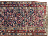 Antique Caucasian rug field with serrated leaves, starburst borders, and violet, red, blue tones.