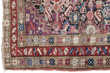 Corner detail of antique Caucasian runner with rare violet, red, blue starburst borders.