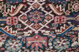 Antique Caucasian runner close-up: serrated geometric motifs, starbursts, and rare color palette.