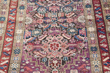Antique Caucasian runner's geometric field, violet and charcoal with serrated leaves, starburst motifs.