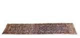 Antique Caucasian runner with allover serrated leaf patterns and colorful starburst borders.