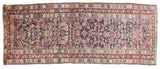 Antique Caucasian runner detail, intricate geometric patterns, starburst borders in aubergine, red, blue.