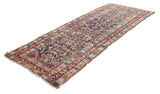 Antique Caucasian runner with a field of serrated leaves and vibrant starburst border motifs.