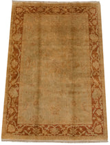 Plush gold wool pile and meandering rust-colored vine border on an Oushak design carpet.