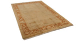 Soft plush wool pile and high luster on a gold Oushak carpet with a copper floral border.