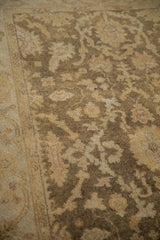 Soft, polished pile of an Indian Oushak rug with olive, gold, and ivory floral patterns.