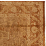 Corner detail of the fluid vine and serrated leaf border in rust and gold tones.