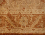 Meandering vine and serrated leaf border in copper and gold on a soft pile rug.