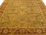 Angled view of the Oushak design carpet's lustrous pile and large-scale arabesque pattern in sage and rust.