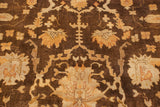 Close-up of the plush wool pile showing bronze and ivory Oushak-style floral designs.