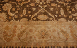 The ivory main border with meandering vines and palmettes against the dark bronze floral field.