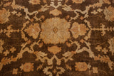 Detailed view of the Oushak carpet's floral vinery in bronze, gold, and antique ivory.