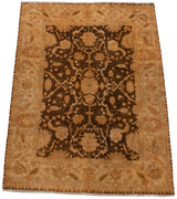 Angled view of the Indian Oushak carpet with bronze and golden-brown palmettes on a dark field.