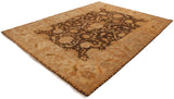 Angled view of a bronze and ivory Oushak carpet with floral and palmette designs.