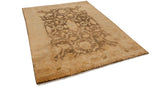 Indian Oushak carpet corner with golden brown palmette border, soft pile, and fringe.