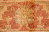 Soft pile texture with washed gold, copper, rust, and olive Oushak design.