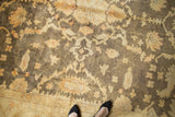 Gold and charcoal floral vinery and palmette border detail on an Indian Oushak rug.