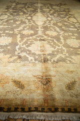 Lustrous Indian Oushak rug detail: charcoal, ivory floral border, and soft fringe.