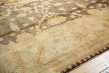 Vintage Indian Oushak carpet showing charcoal floral field and ivory, dusty gold palmette border.