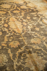 Lustrous gold floral vinery and palmettes on the dark chocolate brown Oushak carpet pile.