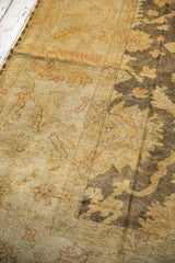 Lustrous dusty gold and dark charcoal Indian Oushak pile with floral vinery.