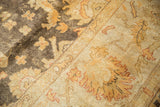 Close-up of polished pile showing dynamic dark brown and gold tones on Oushak rug.