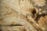 Dynamic lustrous pile of a gold wash Indian Oushak carpet in ivory and deep brown.