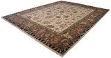 Elaborate brown border with vinery, terracotta, dusty gold, navy motifs on Indian Serapi rug.