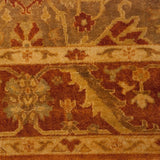 Close-up of the meandering vine and palmette border in rust, copper, and golden olive green.