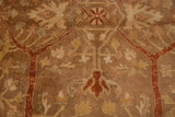 Detailed view of the soft, lustrous pile with Oushak floral motifs in gold, copper, and terracotta.